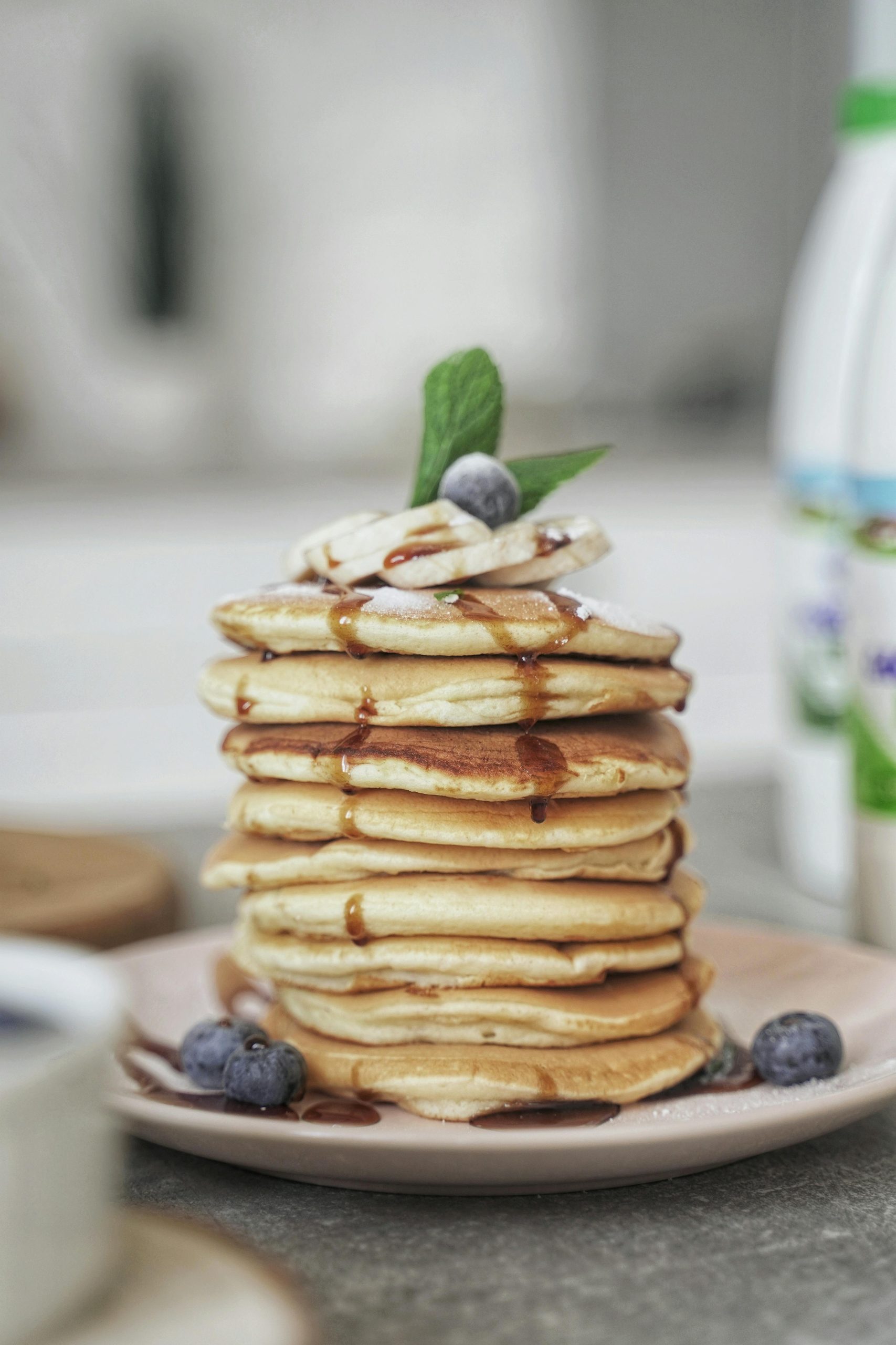 Tasty stack of pancakes with syrup and blueberries, ideal for breakfast imagery.